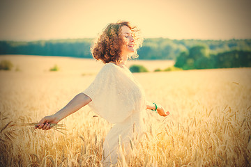 Image showing smiling happy woman in wheat field