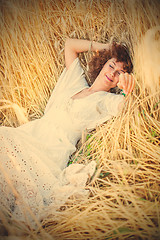 Image showing happy sleeping woman in wheat field