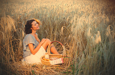 Image showing middle aged beautiful smiling woman with basket outdoors