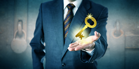 Image showing Business Man Offering A Golden Key In Open Palm