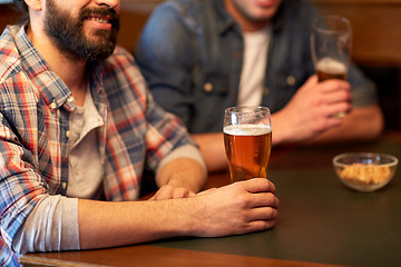 Image showing happy male friends drinking beer at bar or pub