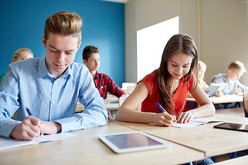 Image showing group of students with books writing school test