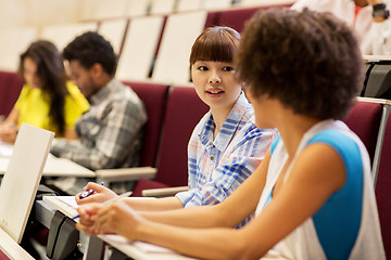 Image showing group of students talking in lecture hall