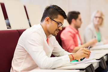 Image showing group of students with notebooks in lecture hall