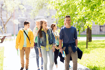 Image showing group of happy teenage students walking outdoors