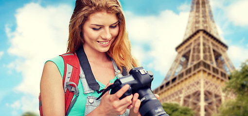 Image showing woman with backpack and camera over eiffel tower