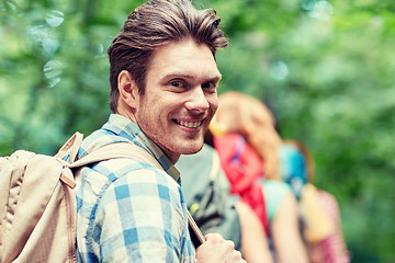 Image showing group of smiling friends with backpacks hiking