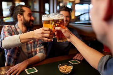 Image showing happy male friends drinking beer at bar or pub