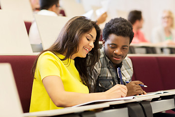 Image showing group of students with notebooks in lecture hall