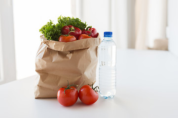 Image showing basket of fresh vegetables and water at kitchen