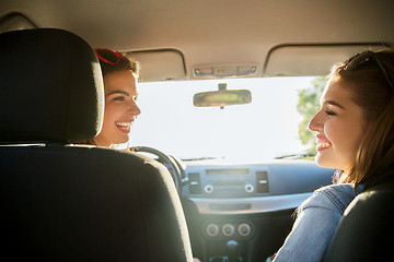 Image showing happy teenage girls or women in car at seaside
