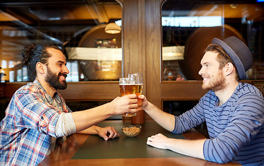 Image showing happy male friends drinking beer at bar or pub