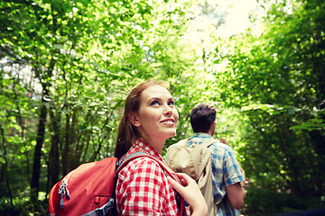 Image showing group of smiling friends with backpacks hiking