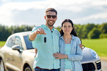 Image showing happy man and woman with car key hugging 