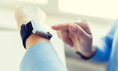 Image showing close up of hands setting smart watch