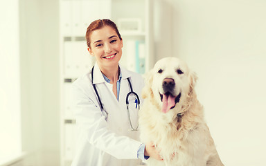 Image showing happy doctor with retriever dog at vet clinic