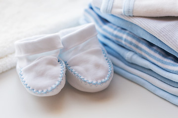 Image showing close up of baby bootees and clothes for newborn