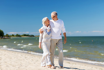 Image showing happy senior couple hugging on summer beach