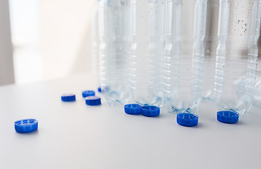 Image showing close up of empty water bottles and caps on table