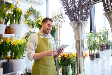 Image showing man with tablet pc computer at flower shop