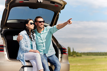 Image showing happy couple hugging at open hatchback car trunk