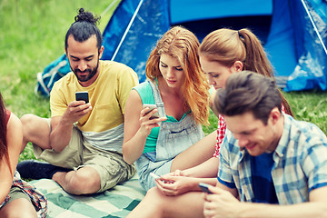 Image showing friends with smartphone and tent at camping