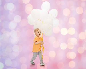 Image showing happy little baby boy with bunch of balloons