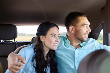 Image showing happy man and woman hugging in car