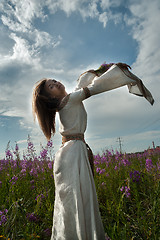 Image showing Beautiful girl relaxing among flowers