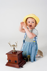 Image showing Little baby girl with retro phone