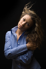 Image showing Attractive brunette woman in blue shirt