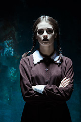 Image showing Portrait of a young girl in school uniform as killer woman