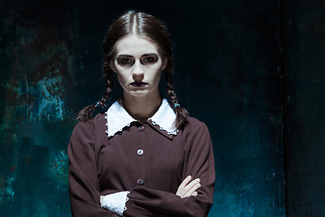 Image showing Portrait of a young girl in school uniform as killer woman