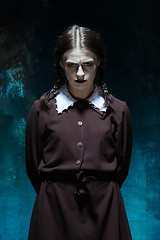 Image showing Portrait of a young girl in school uniform as killer woman