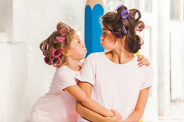 Image showing Little girl playing with her mother