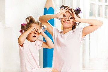 Image showing Little girl playing with her mother