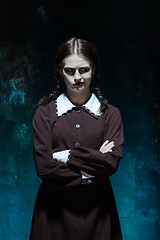 Image showing Portrait of a young girl in school uniform as killer woman