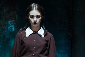 Image showing Portrait of a young girl in school uniform as killer woman