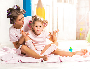 Image showing Little girl playing with her mother