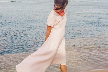 Image showing Woman walking on the beach