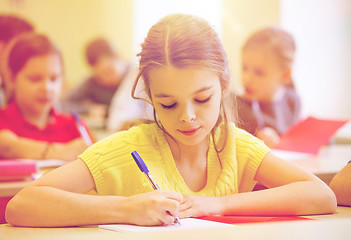 Image showing group of school kids writing test in classroom