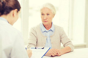 Image showing doctor with clipboard and senior woman at hospital