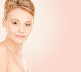 Image showing beautiful young woman face over beige background