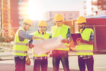 Image showing group of builders with blueprint and clipboard