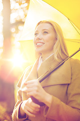 Image showing woman with yellow umbrella in the autumn park