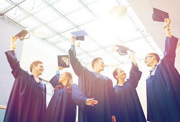 Image showing group of happy students in mortarboards at school