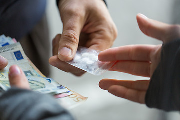 Image showing close up of addict buying dose from drug dealer