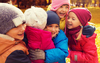 Image showing group of happy children hugging in autumn park