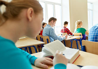 Image showing group of students with books writing school test
