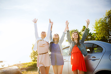 Image showing happy teenage girls or women near car at seaside